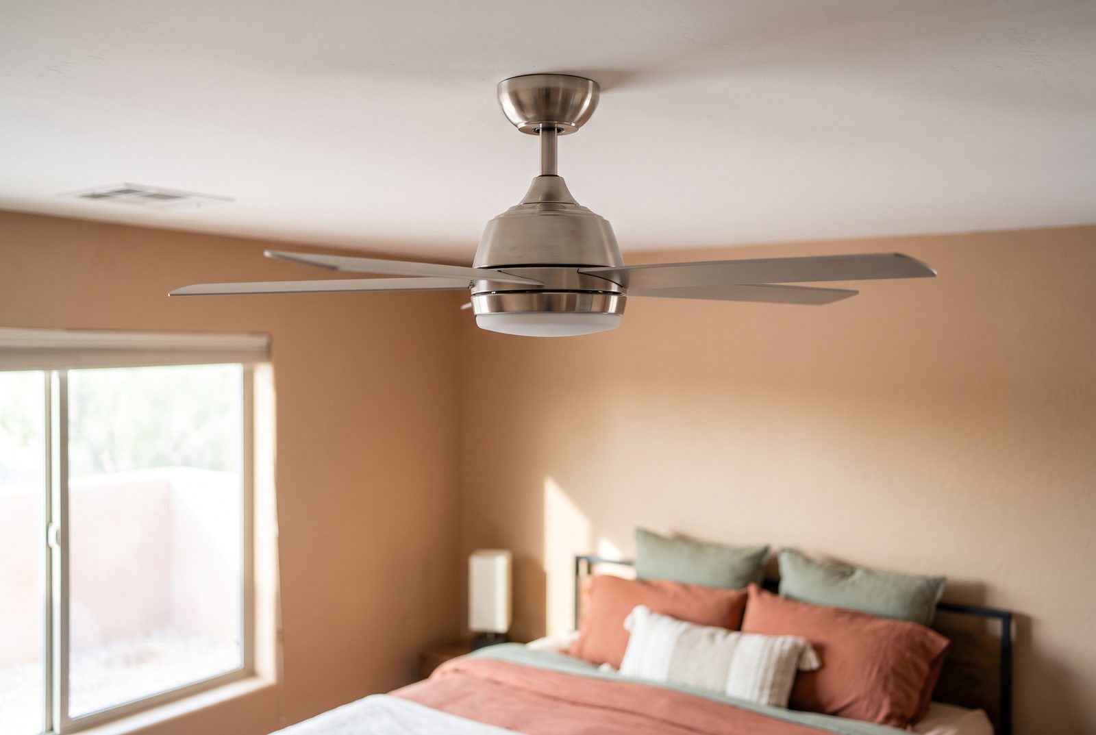Brushed-nickel ceiling fan installed in a Tucson bedroom