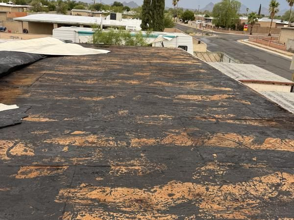 Worn commercial flat roof surface in Tucson showing widespread deterioration