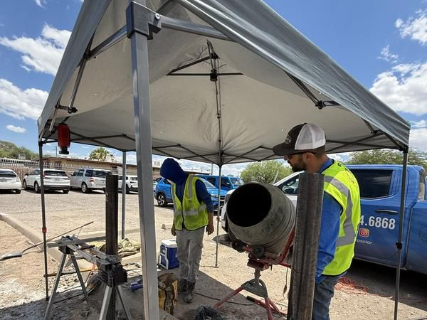 Saguaro Solar roofing crew staging equipment at a Tucson commercial job site