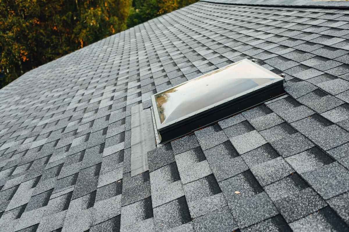 Asphalt shingle roof with a skylight on a Tucson home
