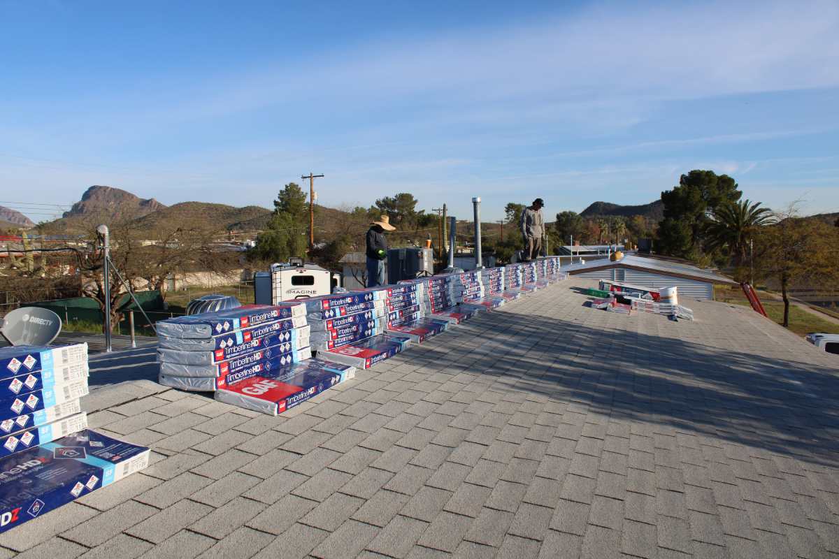 Roofing materials staged on a flat commercial roof in Tucson