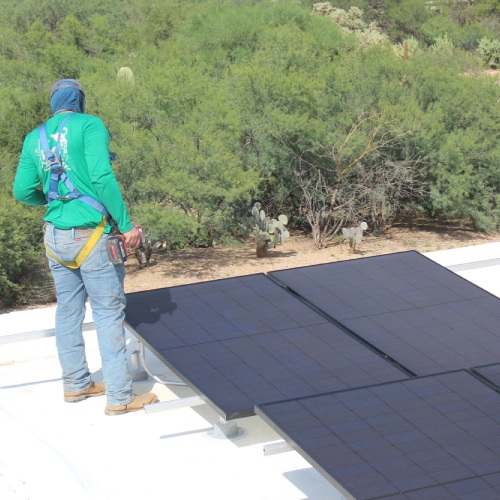 Saguaro Solar technician installing solar panels in Tucson